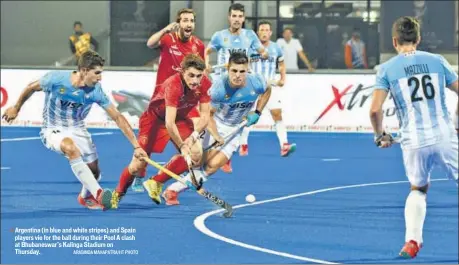  ?? ARABINDA MAHAPATRA/HT PHOTO ?? Argentina (in blue and white stripes) and Spain players vie for the ball during their Pool A clash at Bhubaneswa­r’s Kalinga Stadium on Thursday.