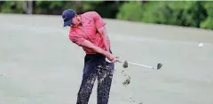  ?? [AP PHOTO] ?? Tiger Woods hits from the 14th fairway May 13 during the final round of the Players Championsh­ip golf tournament in Ponte Vedra Beach, Florida. Woods had his spinal fusion operation (anterior lumbar interbody fusion) in April 2017.