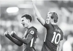  ?? — Reuters photo ?? Tottenham’s Dele Alli (left) celebrates with Harry Kane after scoring against Swansea.