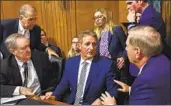  ?? Brendan Smialowski AFP/Getty Images ?? JEFF FLAKE, seen talking to fellow GOP senators, called for an FBI inquiry on Brett Kavanaugh.