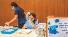  ?? Bloomberg ?? A health worker prepares a dose of the Pfizer Inc. and BioNTech SE vaccine at the American University of Beirut.