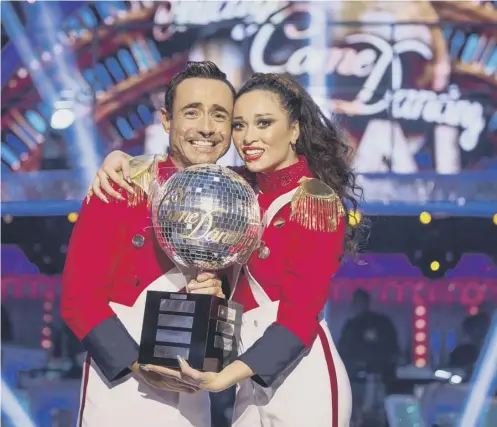  ??  ?? 0 Joe Mcfadden and Katya Jones with the glitterbal­l trophy after they won the final of Strictly Come Dancing on Saturday night