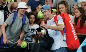  ?? Hsiou. Photograph: Darrian Traynor/Getty Images ?? Alex de Minaur takes a selfie with fans after winning his first-round match against Hsu Yu