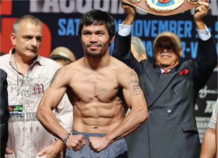  ?? AP FILE PHOTO ?? Manny Pacquiao (center), of the Philippine­s, poses on the scale during a weigh-in on November 4, 2016 in Las Vegas.
