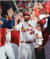  ?? MICHAEL B. THOMAS/AP ?? Cardinals designated hitter Paul Goldschmid­t is welcomed back to the dugout after his two-run home run in the third inning.
