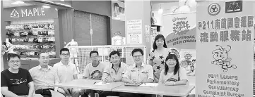  ??  ?? The P211 Lanang Mobile Service Team set up by SUPP Dudong and Bukit Assek branches at a shopping mall. Joseph is seated, second right.