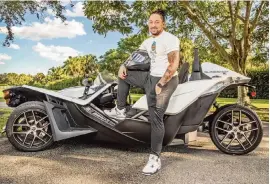  ?? AL DIAZ adiaz@miamiheral­d.com ?? Dolphins wide receiver Albert Wilson shows off his three-wheeled Polaris Slingshot SL during an day off in Davie. ‘It exactly fits me,’ Wilson said.