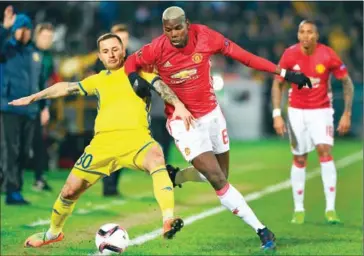  ?? ALEXANDER NEMENOV/AFP ?? Manchester United’s Paul Pogba (right) fights for the ball with Rostov’s Fedor Kudryashov during their UEFA Europa League round-of-16 match at Olimp-2 Arena in Rostov-on-Don on March 9.