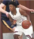  ?? JOHN KLEIN / FOR THE JOURNAL SENTINEL ?? The Falls’ Jalen Dixon drives toward the basket on Friday.