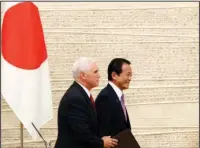  ?? The Associated Press ?? TOKYO: U.S. Vice President Mike Pence, left, and Japanese Deputy Prime Minister and Finance Minister Taro Aso walk together after their joint press conference Tuesday at the prime minister’s office in Tokyo. Pence said the U.S. would work with Japan,...