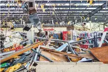  ?? AFP ?? The interior of a store that had the storefront ripped off in Millville, Florida. Some of the hardest-hit communitie­s have yet to report any fatalities.