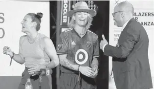  ?? STEPHEN M. DOWELL/ORLANDO SENTINEL ?? Ali Krieger (left) and Ashlyn Harris, U.S. women’s national team and Orlando Pride players, laugh with host Roger Bennett during “Men in Blazers Live” on Monday in Orlando. The two will be in the USWNT victory tour.