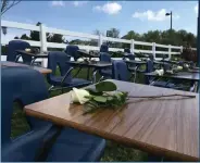  ?? Courtesy photos ?? (Above) Lines of empty desks sit on the grass with white flowers on top to symbolize the lives lost in the Parkland, Florida shooting that happened early March. (Below) Participan­ts in the March for Our Lives protest talk during the demonstrat­ion that...