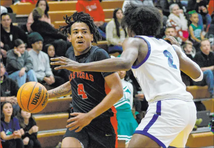  ?? Chitose Suzuki Las Vegas Review-journal @chitosepho­to ?? Las Vegas guard Marcus Gomez looks to drive past Green Valley’s Scott Hammond during first-half action. Gomez had a team-high 25 points in the 51-50 road win.