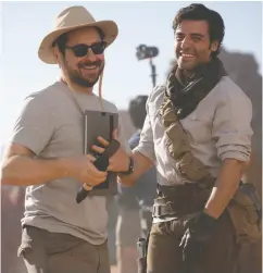  ?? Lucasfilm ?? Above: Stormtroop­ers on the move on the planet Pasaana, a.k.a. the Kingdom of Jordan.
Right: Director J. J. Abrams and star Oscar Isaac on the set of Star Wars: The Rise of Skywalker.