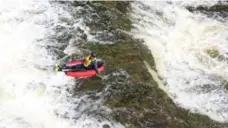  ?? JONATHAN FORANI ?? Reporter Jonathan Forani rides a “RiverBug,” an inflatable one-man “cata-raft” down falls on the Grand River near Elora.