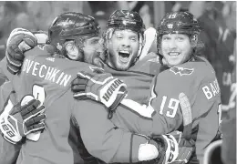  ?? ALEX BRANDON/AP ?? Washington Capitals defenseman John Carlson, center, celebrates his goal against the Vegas Golden Knights with Alex Ovechkin, left, of Russia, and Nicklas Backstrom, right, of Sweden, during the second period in Game 4 of the NHL hockey Stanley Cup Final. Carlson was reisigned in the offseason as part of a plan that gave their Capitals their one of their deepest defenses in team history.