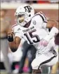  ?? Rogelio V. Solis Associated Press ?? MYLES GARRETT of Texas A&M zeroes in on ballcarrie­r. His team plays UCLA on Saturday.