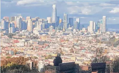  ?? Carl Nolte/The Chronicle ?? The San Francisco skyline, as seen from Bernal Heights, glitters as the sun returns after a rain this month.