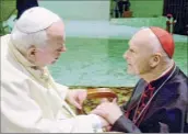  ?? Massimo Sambucetti / Associated Press ?? U.S. Cardinal Theodore Edgar Mccarrick, right, archbishop of Washington, D.C., shakes hands with Pope John Paul II in 2001. Mccarrick was accused of sexual misconduct.