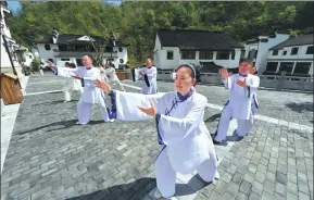  ?? YANG TAO / FOR CHINA DAILY ?? Tai chi enthusiast­s practise their skills in Baokang county, Hubei province.