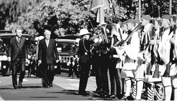  ??  ?? Pavlopoulo­s escorts Erdogan (left) as they inspect a guard of honour during a welcome ceremony in Athens, Greece. — Reuters photo