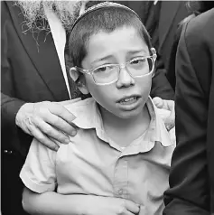  ?? — AFP photo ?? Moshe reacts as he arrives at the Nariman (Chabad) house in Mumbai.