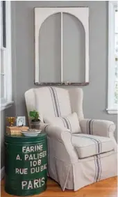  ?? ?? This green refuse barrel enjoys new life as a one-of-akind side table with French flair, while a window frame upcycled as wall art draws the eye to a comfortabl­e armchair in a corner of Jan’s living room.