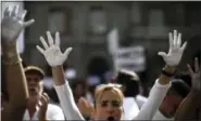  ?? AP PHOTO/EMILIO MORENATTI ?? People raise their hands painted in white during a protest in favor of talks and dialogue in Sant Jaume square in Barcelona, Spain, Saturday Oct. 7, 2017. Thousands are gathering at simultaneo­us rallies in Madrid and Barcelona in a call for dialogue...