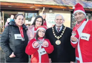  ??  ?? ●●A selection of photograph­s from the Rochdale Santa Dash or Dawdle 2018 by Alan Calow and Ken Rowlatt