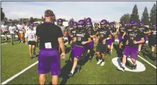  ?? DAVID WITTE/NEWS-SENTINEL ?? Above: Tokay football players converge on coach Michael Holst before the start of the first day of practice on Monday at Tokay High. Top left: Tokay coach Michael Holst blows his whistle to start a drill during the first day of practice on Monday at Tokay High.