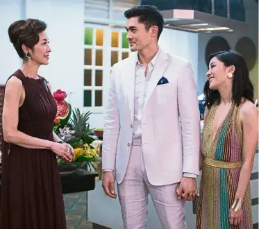  ??  ?? Crazy Rich Asians, which stars (from left) Tan Sri Michelle Yeoh, Golding and Wu, was partially shot in Malaysia. — Handout. (Right) Director Chu (seen with Wu) says the movie will appeal to everyone, including mainstream American moviegoers. — AP