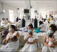  ??  ?? Mothers carrying their newborn babies queue for a check-up inside the maternity ward of the government-run Dr Jose Fabella Memorial Hospital, amid the coronaviru­s disease (Covid-19) outbreak, in Manila, yesterday.