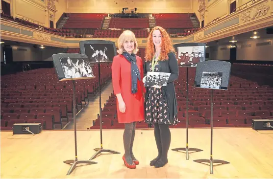  ?? Picture: Kim Cessford ?? Caird Hall manager Susan Gillan, left, and Kristen Segerius with some of the photos in the Dundee music venue.