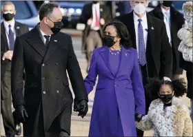  ?? JACQUELYN MARTIN — THE ASSOCIATED PRESS ?? Vice President Kamala Harris, and her husband, Doug Emhoff, and family walk in front of the White House during a presidenti­al escort to the White House on Wednesday.