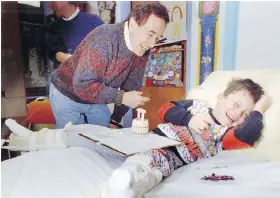  ??  ?? Bob McGrath, seen entertaini­ng a patient in the Royal University Hospital pediatrics unit in 1993, missed only one Telemiracl­e telethon up until 2015.