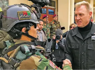  ?? ROBERT BURNS/ASSOCIATED PRESS ?? Acting Secretary of Defense Patrick Shanahan greets an Afghan commando at Camp Commando, Afghanista­n, on Monday. Shanahan followed up the unannounce­d visit with another to Iraq on Tuesday.