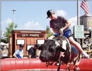  ?? PHOTO BY JESI YOST — FOR MEDIANEWS GROUP ?? Jason Karwachi, 12, of Gilbertsvi­lle rides on a mechanical bull.