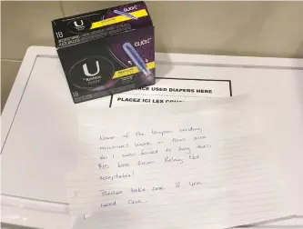  ?? THE CANADIAN PRESS ?? An anonymous note and a $15 box of tampons is shown in a women’s washroom at the Calgary Internatio­nal Airport on Nov. 26, 2017. Though many shocked at the price, women in remote Indigenous communitie­s often pay that much or more for feminine hygiene...