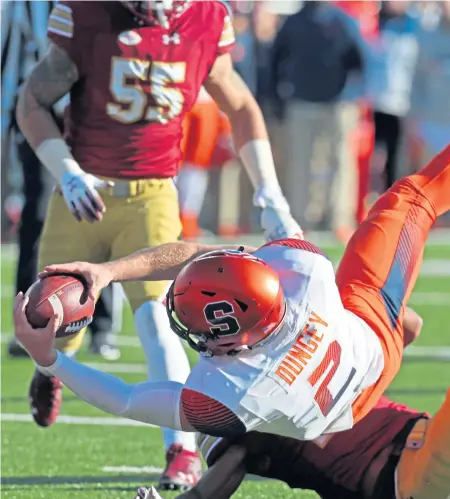  ?? STUART CAHILL / BOSTON HERALD ?? ROLLED OVER: Boston College defensive back Taj-Amir Torres is helpless to stop Syracuse’s Eric Dungey from stretching for a touchdown yesterday at Alumni Stadium. The Eagles dropped their third straight, 42-21, to end the regular season 7-5.