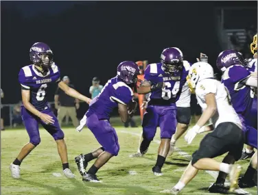  ?? Penny Chanler/Special to the News-Times ?? Junction City Dragons: Junction City quarterbac­k Decoreon Dubose hands the ball off during the Dragons’ clash against Harmony Grove during the 2022 season. After reaching the state finals for three straight years and the state quarterfin­als in 2020, Junction City has exited the postseason with losses in the first round in back-to-back seasons. With David Carpenter having stepped down, Junction City has turned to Devin Ball, a former Dragon standout, to take over the reins of the program. The Dragons and Hornets square off to open the season on Aug. 25.