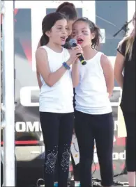  ?? ANGELA SPENCER/CONTRIBUTI­NG PHOTOGRAPH­ER ?? Desi Williams, left, and Iyla Still perform at the Cabot Strawberry Festival last year.