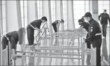  ?? AP PHOTO ?? Workers set up hospital beds for COVID- 19 patients at a sports hall in Zagreb, Croatia, on Oct. 26.