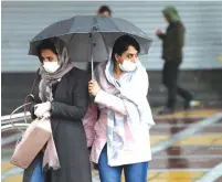  ?? (WANA/Reuters) ?? WOMEN WEAR protective masks to prevent contractin­g the coronaviru­s in Tehran on Tuesday. Iran has surpassed China as the center of the COVID-19 epidemic.