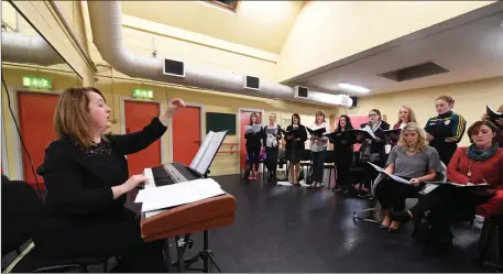  ??  ?? Siamsa Tíre’s Choral Mistress Geraldine Hurley leads some of the National Folk Theatre’s choral section during rehearsals backstage at Siamsa’s theatre in Tralee Town Park.