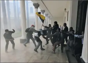  ?? The Associated Press ?? BRAWL: Opposition lawmakers brawl with pro-government militias who are trying to force their way into the National Assembly during a special session Wednesday coinciding with Venezuela’s independen­ce day, in Caracas. At least five lawmakers were...