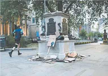  ?? JAMES BECK/THE NEW YORK TIMES ?? A statue of 17th-century slave trader Edward Colston in Bristol, England, was torn from its base and dumped into a harbor.