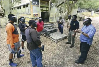  ??  ?? Maui Police Department school resource officers Trinidad Alconcel, Jonathan Honda, Brandon Phillips, Nichole Comilang and Sgt. Lawrence Pagaduan debrief the students after the simulation.