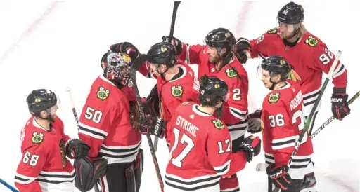  ??  ?? Corey Crawford (50) and the Hawks celebrate their victory Sunday in Game 4, in which they got three goals out of just 14 scoring chances. JASON FRANSON/AP