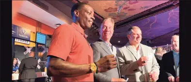  ?? Mike Anthony / Hearst Connecticu­t Media ?? Former UConn football player Darius Butler with Gov. Ned Lamont at Mohegan Sun casino Thursday.